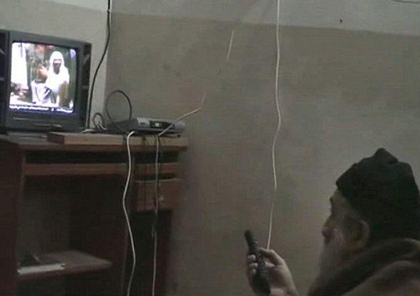 Osama bin Laden watching himself on TV