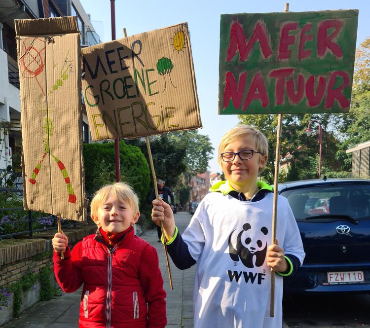 Children holding cardboard placards about green future